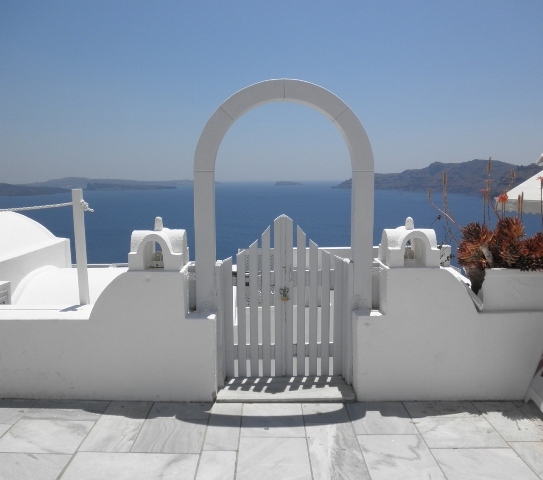 "Gate opening onto to the sea in picture perfect Oia, Santorini"
