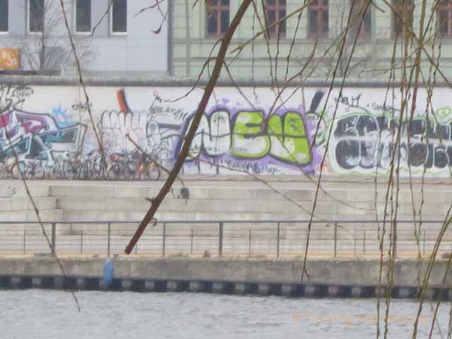 "Graffiti on a remaining section of the Berlin Wall along the River Spree in Kreuzberg borough of Berlin"