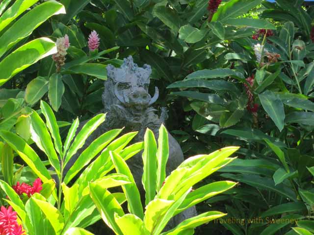 "Sculpture by Jan Fisher on the grounds of the Grand Wailea depicting a half man, half boar hidden among the flora"