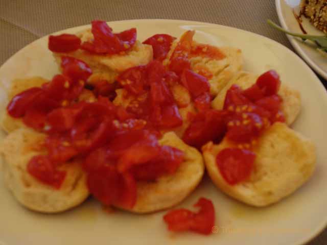 "Fresh bread and tomatoes at the ristorante of Balnearea Beach, Otranto, Italy"