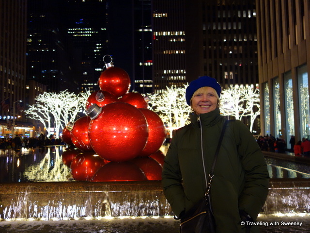 Giant red ornaments adorn a fountain on Sixth Avenue -- New York City at Christmastime
