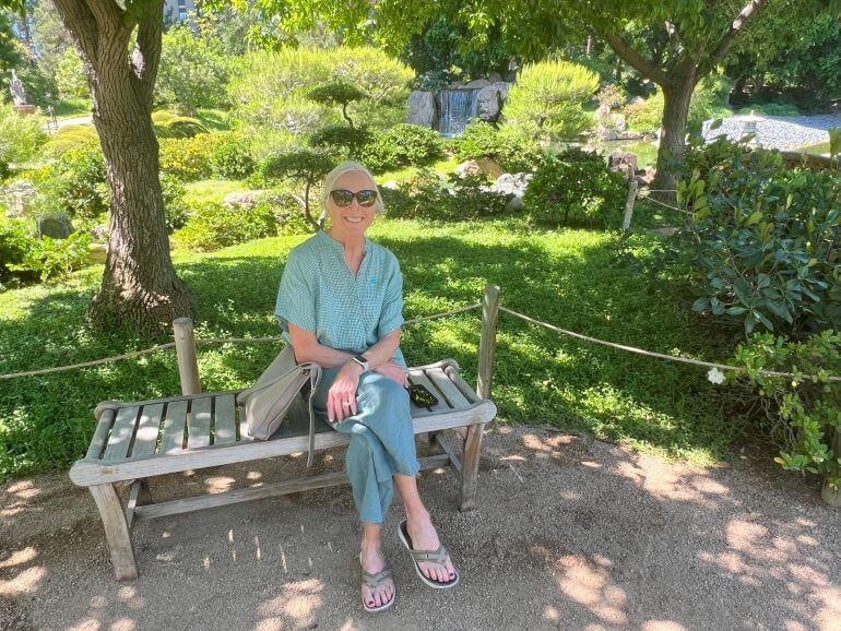 Catherine Sweeney sitting on a bench at Japanese Friendship Garden in Phoenix, Arizona